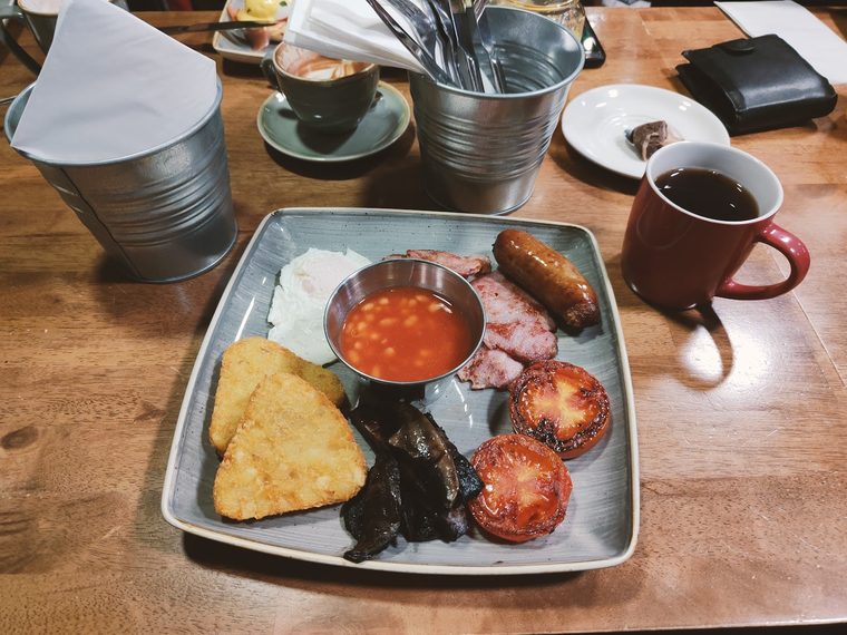 Breakfast tray with black pudding, sausage, hash brown and beans
